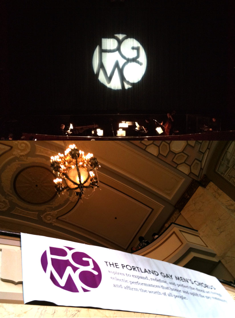 The PGMC monogram projected on a stage curtain, and on a venue banner.